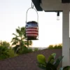 7" Solar Patriotic Glass/Iron Hanging Lantern With LED Lights Cool White - Alpine Corporation